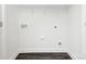 Bright laundry room with washer/dryer hookups, dark wood-look flooring, and wire shelving at 514 Rich St, Rock Hill, SC 29730