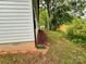 Home's side yard features wood fencing, mulch, mature trees, and lush greenery for privacy at 514 Rich St, Rock Hill, SC 29730