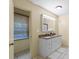 Well-lit bathroom features a double sink vanity, a decorative mirror and a private toilet room at 514 W Sumter St, Shelby, NC 28150