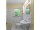 Bathroom with vanity, toilet, and white tiles with a garden window at 514 W Sumter St, Shelby, NC 28150