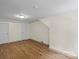 Bright bedroom featuring neutral walls and wood-look floors with multiple closets for storage at 514 W Sumter St, Shelby, NC 28150
