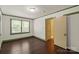 Traditional bedroom features hardwood floors, green trim, and a doorway into an ensuite bath at 514 W Sumter St, Shelby, NC 28150