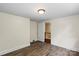 Bedroom with wood-look floors and neutral walls with a view to the staircase at 514 W Sumter St, Shelby, NC 28150