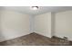 Bedroom with wood-look floors and neutral walls. Single window and standard closet at 514 W Sumter St, Shelby, NC 28150