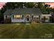 Charming home with a well-manicured lawn and welcoming curb appeal at dusk at 514 W Sumter St, Shelby, NC 28150