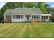 Charming home with a well-manicured lawn, green shutters, and stone accents at 514 W Sumter St, Shelby, NC 28150