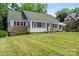 Classic home with green shutters, stone accents, and a lush green lawn at 514 W Sumter St, Shelby, NC 28150