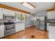 Functional kitchen with stainless steel appliances, lots of cabinets, and wooden floor at 514 W Sumter St, Shelby, NC 28150