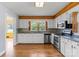 Well-lit kitchen featuring stainless steel appliances, white cabinets, and granite countertops at 514 W Sumter St, Shelby, NC 28150