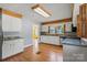 Bright kitchen featuring stainless steel appliances, white cabinets, and hardwood floors at 514 W Sumter St, Shelby, NC 28150
