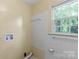 Bright laundry room with tile accents and a window for ventilation at 514 W Sumter St, Shelby, NC 28150