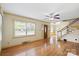 Open living area with hardwood floors, a fireplace and stairs at 514 W Sumter St, Shelby, NC 28150