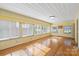Bright sunroom with ample windows and hardwood floors, perfect for relaxation and comfort at 514 W Sumter St, Shelby, NC 28150
