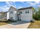 Beautiful home featuring neutral siding, a two-car garage, and a well-manicured lawn on a sunny day at 518 Dutch White Dr, Clover, SC 29710