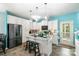 Modern kitchen boasts white cabinets, granite countertops, a kitchen island, and stainless steel appliances at 518 Dutch White Dr, Clover, SC 29710