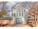 View of the community building featuring blue siding, brick accents and mature trees at 529 N Graham St # 3F, Charlotte, NC 28202