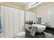 Bright bathroom with modern vanity, vessel sink, and shower with neutral decor at 529 N Graham St # 3F, Charlotte, NC 28202