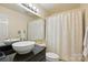 Bathroom features a sleek black vanity, a vessel sink, and a shower with patterned curtain at 529 N Graham St # 3F, Charlotte, NC 28202