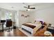Bright bedroom boasts wood floors, neutral walls, ceiling fan and a large window for natural light at 529 N Graham St # 3F, Charlotte, NC 28202