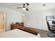 Bedroom features a ceiling fan, a warm brown accent blanket, and neutral paint at 529 N Graham St # 3F, Charlotte, NC 28202
