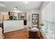 Open concept kitchen dining area features wood floors, glass table, and natural lighting at 529 N Graham St # 3F, Charlotte, NC 28202
