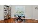 Dining area with wood floors, glass table, and decorative display shelf at 529 N Graham St # 3F, Charlotte, NC 28202
