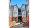 Charming two-story condo with brick accents and a blue-painted walkway against a clear sky at 529 N Graham St, Charlotte, NC 28202