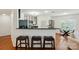 Eat-in kitchen featuring bar seating and stainless steel appliances with light wood floors at 529 N Graham St # 3F, Charlotte, NC 28202