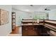 Kitchen area with wood floors, brown cabinets, and stainless steel faucet at 529 N Graham St # 3F, Charlotte, NC 28202