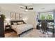 Spacious bedroom with a ceiling fan, area rug, and dedicated workspace at 529 N Graham St # 3F, Charlotte, NC 28202