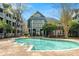 A sparkling community pool surrounded by lush trees and beautifully maintained brick at 529 N Graham St # 3F, Charlotte, NC 28202