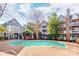 Outdoor pool is surrounded by brick pavers and mature trees, providing a relaxing community space at 529 N Graham St # 3F, Charlotte, NC 28202