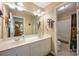 Bathroom featuring double sinks, white cabinets, and a shower/bath combo with tile surround at 5617 Sugarcane Ct, Mint Hill, NC 28227