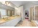 Large bathroom features dual sinks, white cabinets, a large mirror, and a glass enclosed shower at 5617 Sugarcane Ct, Mint Hill, NC 28227