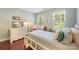 Serene bedroom with wood floors and soft blue walls features a large window and white accents at 5617 Sugarcane Ct, Mint Hill, NC 28227