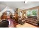 The spacious bonus room features a window for light and cozy furniture for relaxing at 5617 Sugarcane Ct, Mint Hill, NC 28227