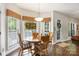 Bright breakfast nook with a round wooden table, cushioned chairs, and a decorative stained glass window at 5617 Sugarcane Ct, Mint Hill, NC 28227