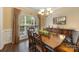 Elegant dining room featuring a large wooden table, ornate chairs, and natural light at 5617 Sugarcane Ct, Mint Hill, NC 28227