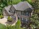 Aerial view of brick home with a dark roof, lush landscaping, and a two-car garage at 5617 Sugarcane Ct, Mint Hill, NC 28227