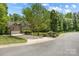 Exterior front view of a two-story brick home with attached garage, garden, and curb appeal at 5617 Sugarcane Ct, Mint Hill, NC 28227