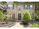 Welcoming front entrance featuring a black door with a wreath, surrounded by lush landscaping at 5617 Sugarcane Ct, Mint Hill, NC 28227
