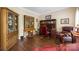 Cozy home office with rich wood flooring, built-in bookshelves, and a comfortable leather chair at 5617 Sugarcane Ct, Mint Hill, NC 28227