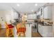 Well-lit kitchen with white cabinets, granite countertops, and stainless steel appliances at 5617 Sugarcane Ct, Mint Hill, NC 28227