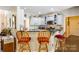 Stylish kitchen with granite countertops, stainless steel appliances, and breakfast bar seating at 5617 Sugarcane Ct, Mint Hill, NC 28227