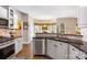 Bright kitchen with stainless steel appliances, granite countertops, and a seamless bar overlooking the breakfast area at 5617 Sugarcane Ct, Mint Hill, NC 28227