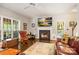 Inviting living room with fireplace, flat screen, plush rug, hardwood floors, and plenty of natural light at 5617 Sugarcane Ct, Mint Hill, NC 28227