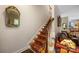 Staircase with carpet runner and wood railing, leading to the upper level of the home at 5617 Sugarcane Ct, Mint Hill, NC 28227