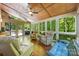 Bright sunroom featuring a wood ceiling, hardwood floors, and multiple seating areas with natural light at 5617 Sugarcane Ct, Mint Hill, NC 28227
