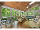 Relaxing sunroom with wood ceiling, comfortable seating, and abundant natural light filtering through large windows at 5617 Sugarcane Ct, Mint Hill, NC 28227
