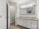 Bathroom featuring double vanity with granite countertops and modern fixtures at 5818 Downfield Wood Dr, Charlotte, NC 28269